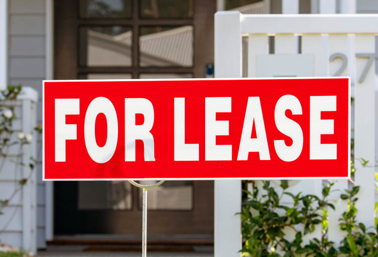 A for lease sign in the front yard of a residential property